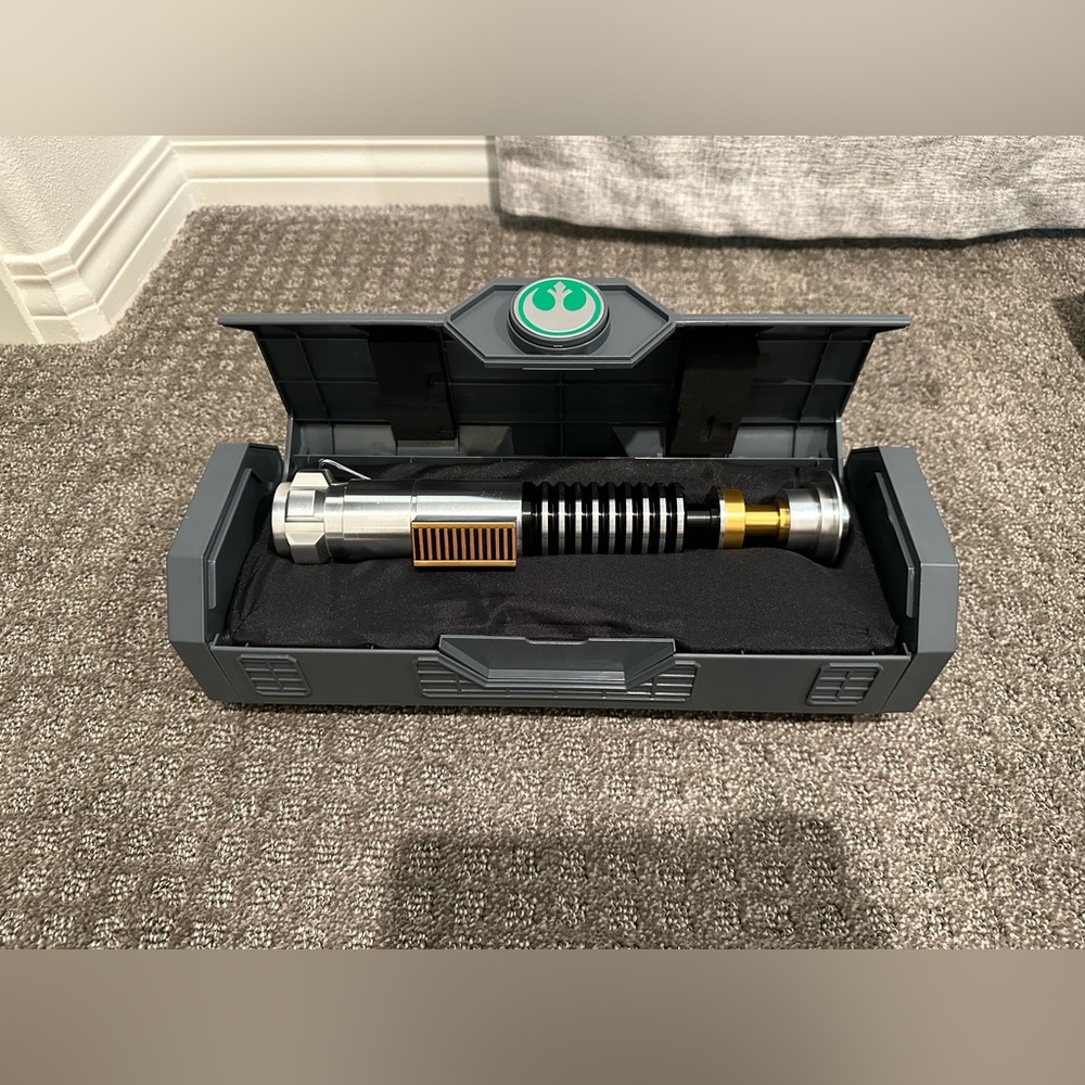 Luke Skywalker legacy lightsaber hilt with stand.